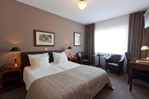 Postel nebo postele na pokoji v ubytování Hotel De Hofkamers