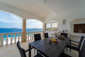 a dining room with a table and a view of the ocean at Holiday House Nova in Blato