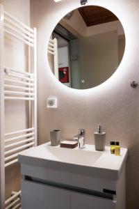 a bathroom with a sink and a mirror at MM luxury studios&villas in Kompítsion +21 photos