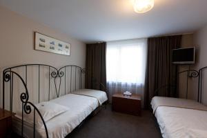 Postel nebo postele na pokoji v ubytování Hotel De Hofkamers