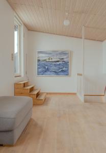 a living room with a couch and a painting on the wall at Harbour View / 2BR / City Centre in Tórshavn