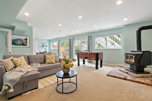 a living room with a couch and a fireplace at Marbella Lane - Charming & Serene home in Pacifica in Pacifica