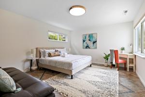 a living room with a bed and a couch at Marbella Lane - Charming & Serene home in Pacifica in Pacifica
