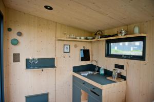 a kitchen in a tiny house with a sink at Sleep Space 1 - Green Tiny Spot Dolmar 
