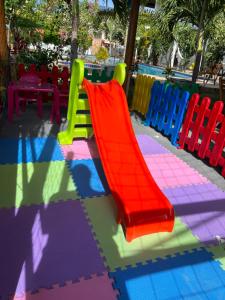 a colorful playground with a slide in a restaurant at Milano Hotel Pousada Canoa Quebrada in Canoa Quebrada