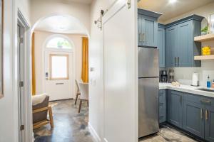 a kitchen with blue cabinets and an archway at The Charmer in Salt Lake City