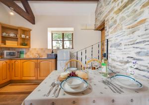 a kitchen with a table with dishes on it at Cysgod-y-coed in Builth Wells