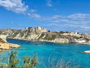 a castle on top of a hill above a body of water at Antonia's Home - casa per le vacanze con giardino e veranda attrezzati in San Domino