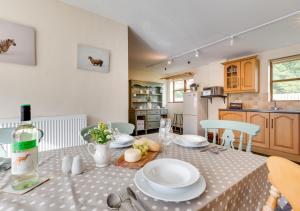 a kitchen with a table with plates and a bottle of wine at Hafan Llewelyn in Builth Wells