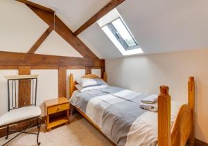 a bedroom with a bed and a skylight at Hafan Llewelyn in Builth Wells