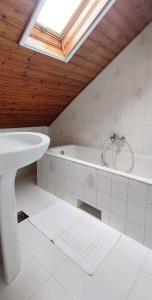 a bathroom with a sink and a bath tub at Holiday home in Balatonkeresztur 19387 in Hegy