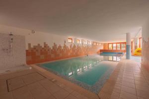 a large swimming pool in a building with a swimming pool at Relax House Budapest in Budapest
