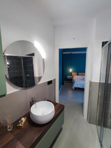 een badkamer met een wastafel en een spiegel bij Marconi Apartment in Chieri