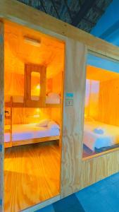 two bunk beds in a room with wooden floors at Area Surf House in Muros