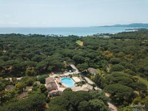 an aerial view of a house with a swimming pool and trees at Hôtel Palombaggia in Porto-Vecchio