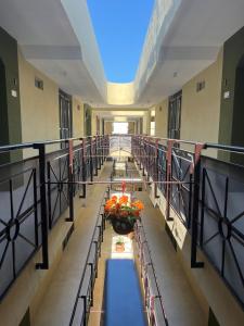 a hallway with tables and flowers in a building at LOL-HA Hotel Boutique in Cancún