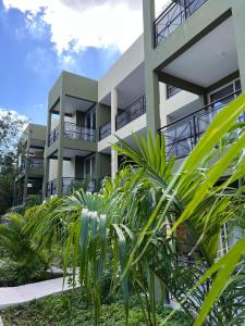 an apartment building with plants in front of it at LOL-HA Hotel Boutique in Cancún