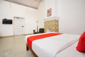 a bedroom with a large bed and a fireplace at OYO Hotel Merimaid in Munnar