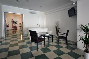a living room with a couch and a table and chairs at Hotel Bagni Arcobaleno in Deiva Marina