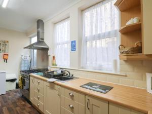 a kitchen with a sink and a stove at Sunnyside Holiday Apartment 1 in Bridlington