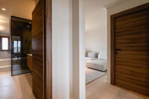 a room with a door leading to a bedroom at Le Nid du Favre II - Large 2 room with breathtaking view of the lake in Annecy
