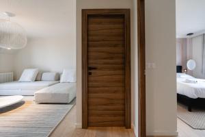 a room with a door leading to a bedroom at Le Nid du Favre II - Large 2 room with breathtaking view of the lake in Annecy