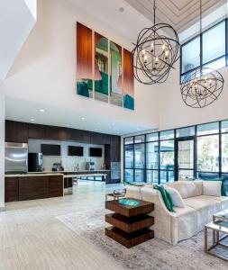 a living room with a couch and a kitchen at Locale at the Galleria - Houston in Houston