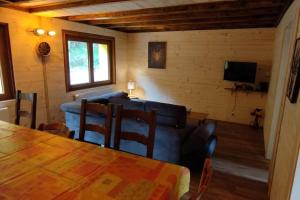 a living room with a couch and a table at Maison de montagne vue magnifique in Ventron