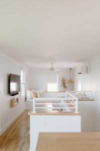 a white room with a bed and a couch at The Sunsetter by WB Abodes in Wrightsville Beach