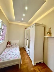 a bedroom with a bed and a white cabinet at Apartman Guberinic,Tivat ,trosoban stan in Tivat
