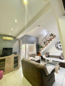 a living room with a couch and a staircase at Apartman Guberinic,Tivat ,trosoban stan in Tivat