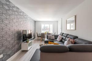 a living room with a couch and a tv at Sweet Inn - Adelaide Square in Dublin