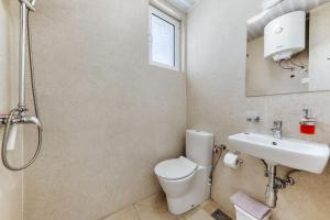 a bathroom with a toilet and a sink and a shower at MonteCasa Seaview Rooms in Dobra Voda
