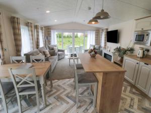 uma cozinha e sala de estar com mesa e cadeiras em Stag Lodge em York