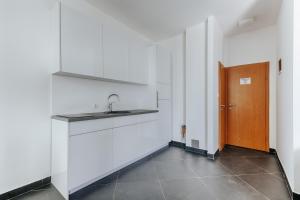 a kitchen with a sink and a wooden door at MonteCasa Seaview Rooms in Dobra Voda