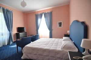 Postel nebo postele na pokoji v ubytování Hotel Milano Pool & Garden