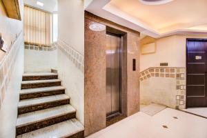 a set of stairs in a building with a door at Capital O 5381 The Emirates Hotel in Bangalore