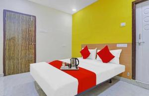 a bedroom with a bed with red and yellow walls at OYO Flagship Hotel Mint Residency in New Delhi