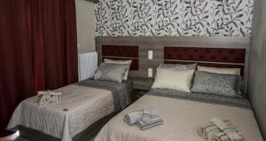 a bedroom with two beds with towels on them at Senia Holidays in Preveza