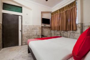 a bedroom with a large bed and a television at Hotel Holiday Rani Gunj Opp Punjab national bank in Secunderabad