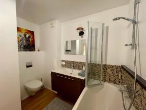 a bathroom with a shower and a toilet and a sink at Happy Viesturs in Valmiera