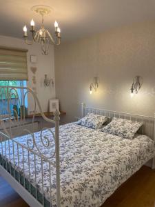 a bedroom with a bed and a chandelier at Happy Viesturs in Valmiera