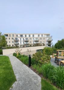 a apartment building with a park in front of it at Apartament Gdańska in Gdańsk