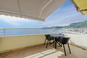 a balcony with a table and chairs and the ocean at MonteCasa Seaview Rooms in Dobra Voda