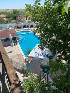 a view of a swimming pool with a table and a bench at Guest House KOLESHEVI in Byal Izvor
