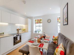 a kitchen and living room with a couch and a table at The Mill Townhouse in Pateley Bridge