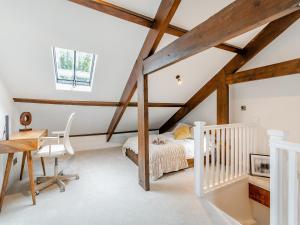 a bedroom with a bed and a desk at The Mill Townhouse in Pateley Bridge