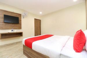 a bedroom with a bed with a television on the wall at OYO 24372 Hotel Cloud 9 in Zirakpur