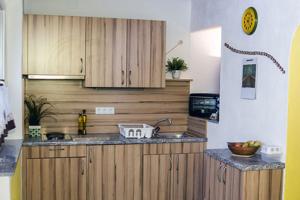 a kitchen with wooden cabinets and a counter top at Ferienwohnung Haus Stadler in Bad Ischl