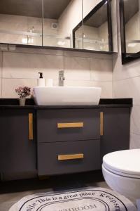 a bathroom with a sink and a toilet at Cozy Garden Flat by SUMMITVISTA in Istanbul